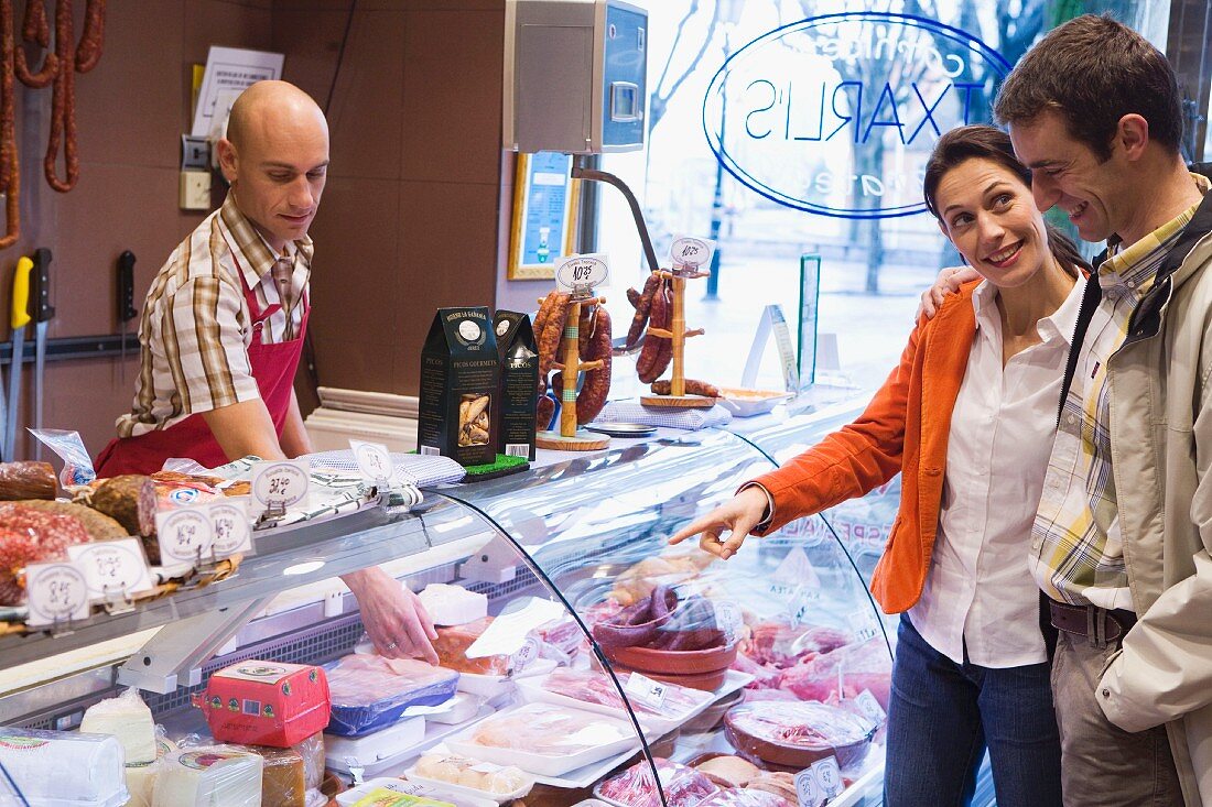 Couple in butcher's shop