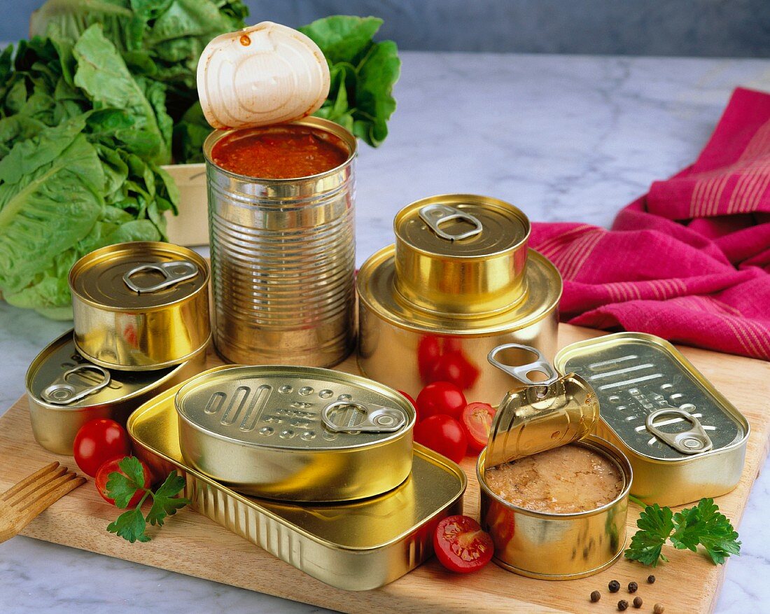 Unlabelled tins of food, some opened