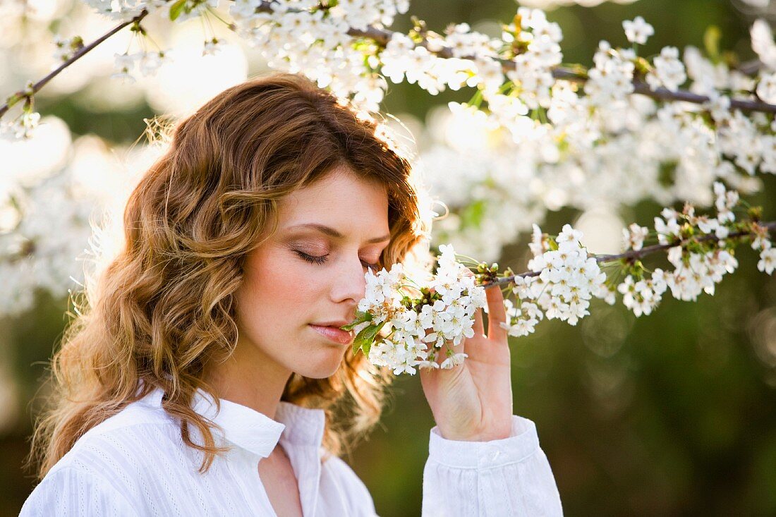 Woman smelling fragrant blossom