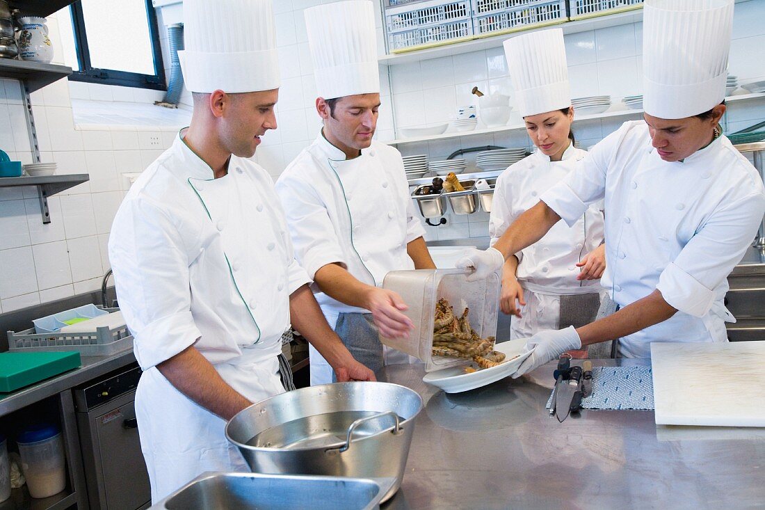 Chefs preparing prawns in a commercial kitchen