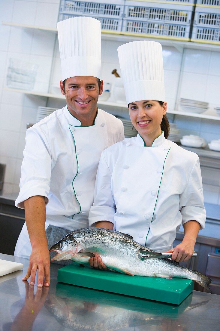 Two chefs with a salmon
