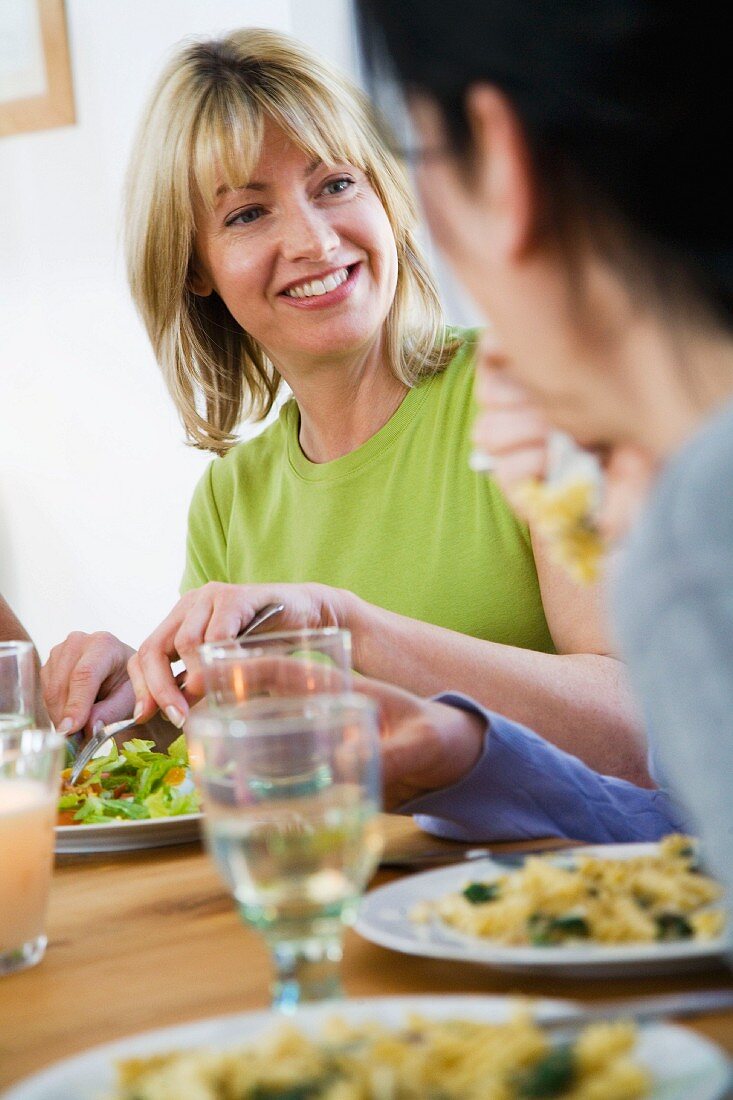 Friends eating dinner in dining room