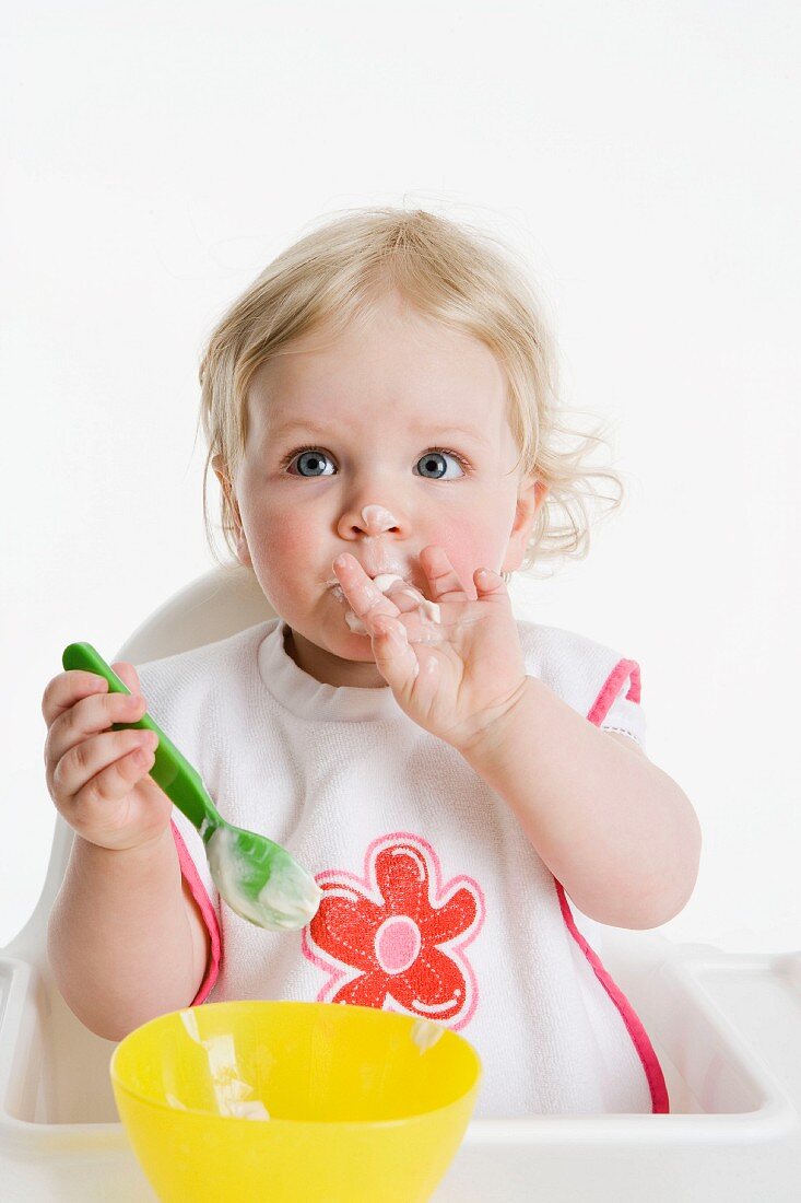 Little girl eating mush