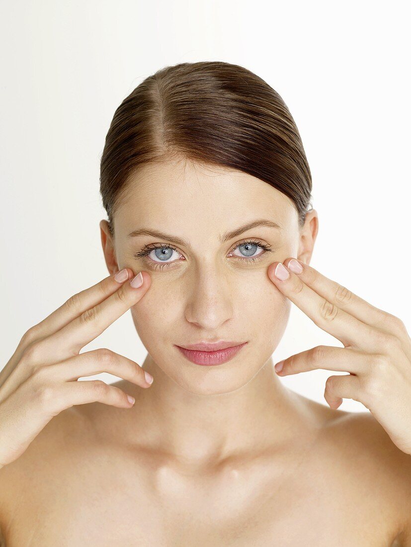 Woman massaging her under-eye area