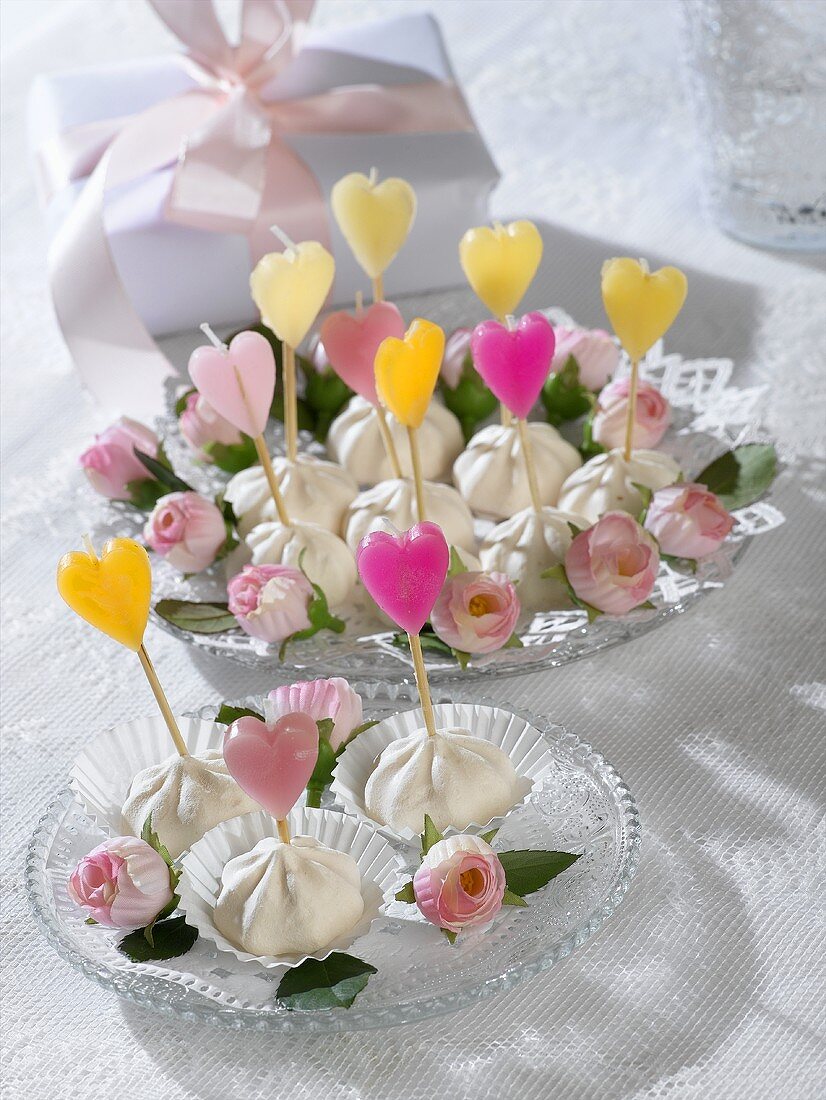Meringues with coloured heart-shaped candles