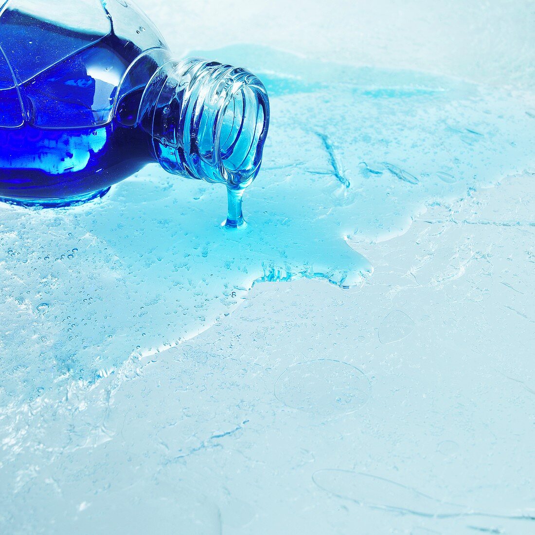 Blue bath product dripping out of bottle