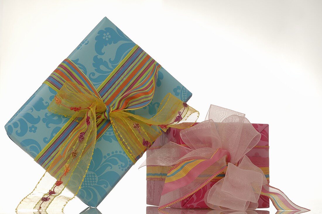 Two gifts tied with coloured ribbons