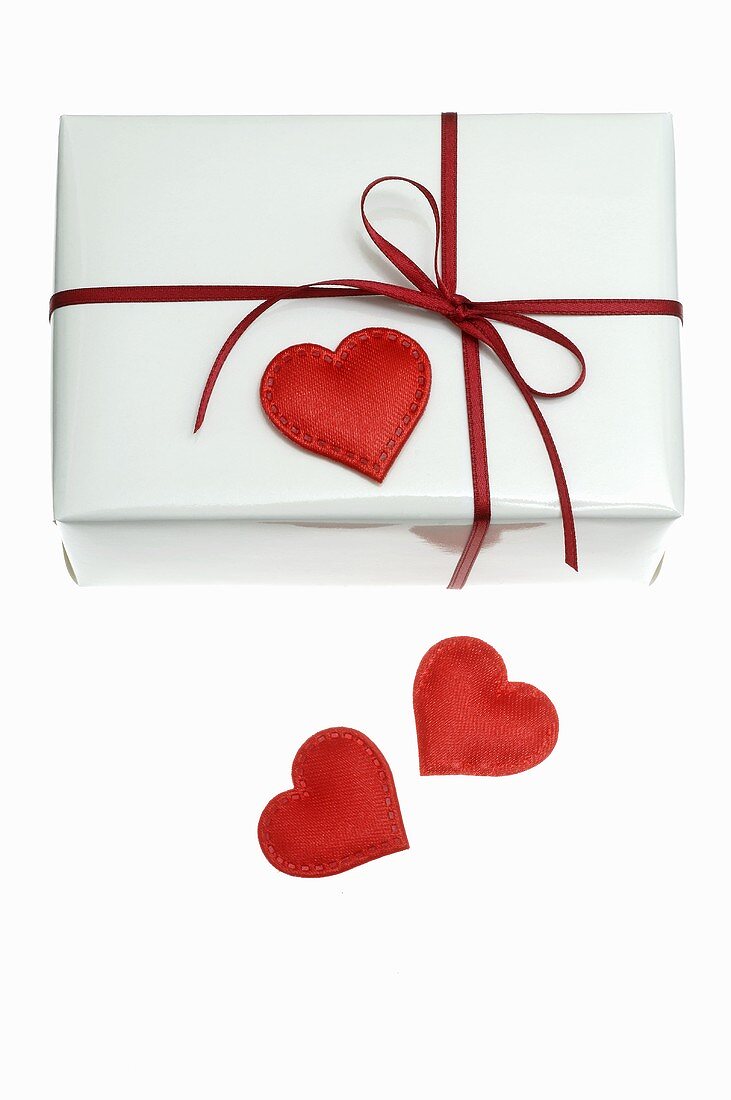 Gift in white wrapping paper with red heart