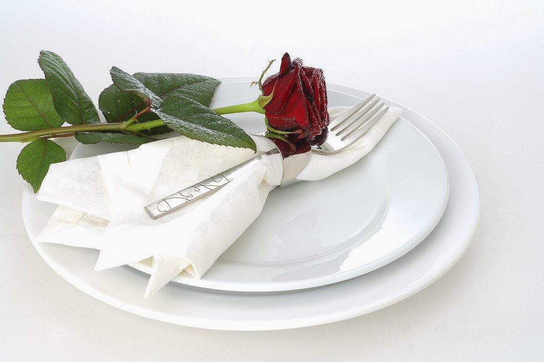 Elegant place-setting with red rose