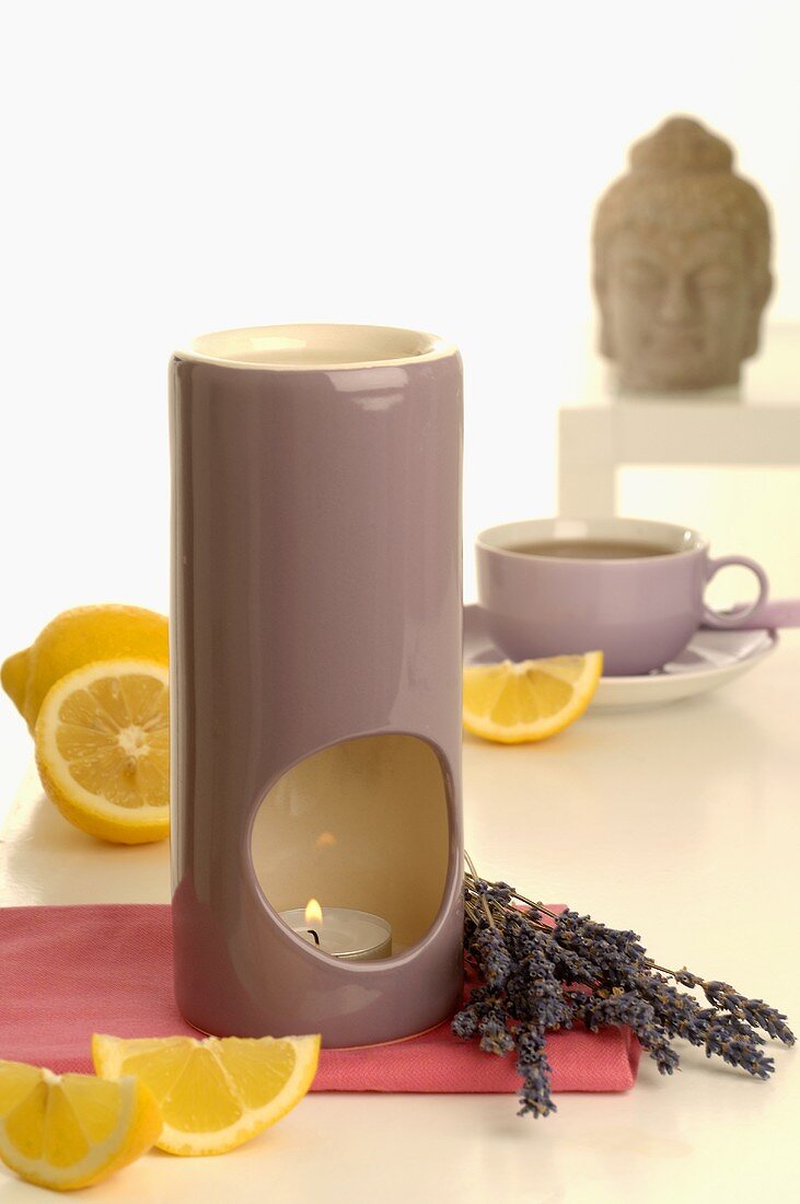 Aroma lamp with lavender & lemon, cup of tea, Buddha head
