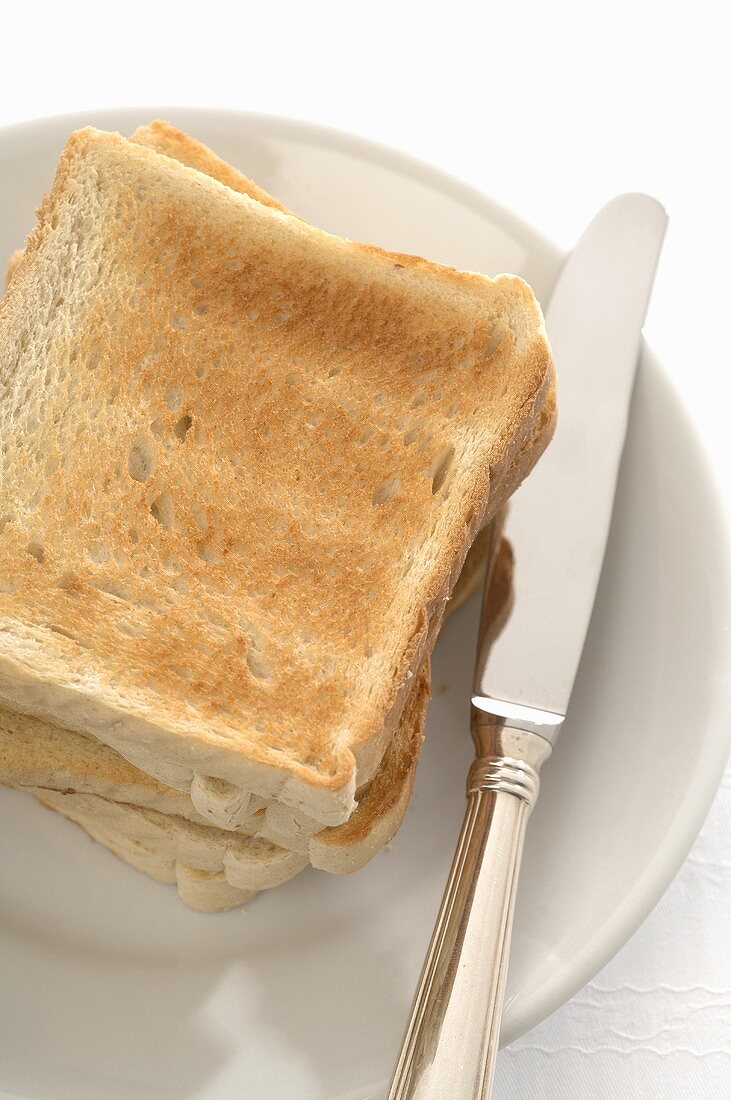 Slices of toast and knife on plate