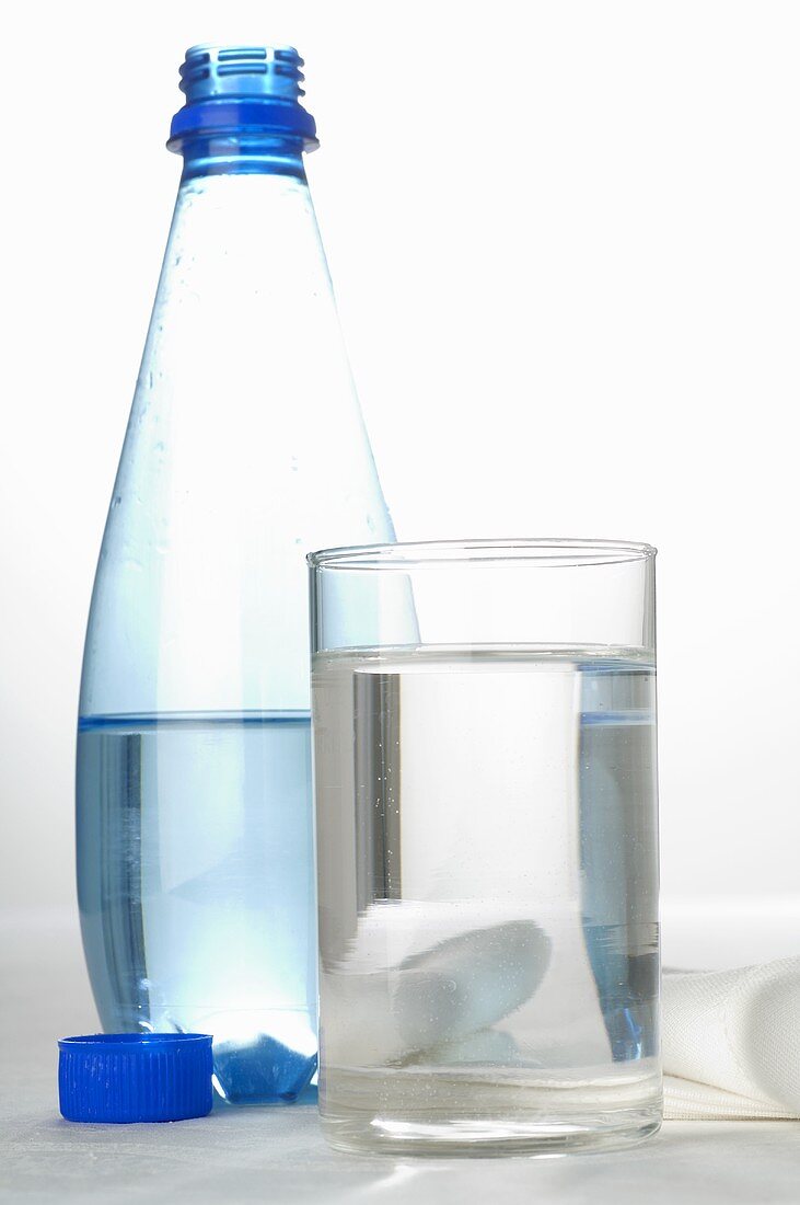 Bottle of mineral water and glass
