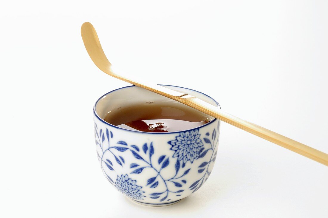 Bowl of tea with bamboo spoon