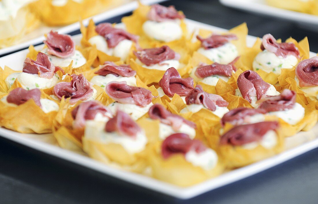 Appetisers with cream cheese and smoked duck breast