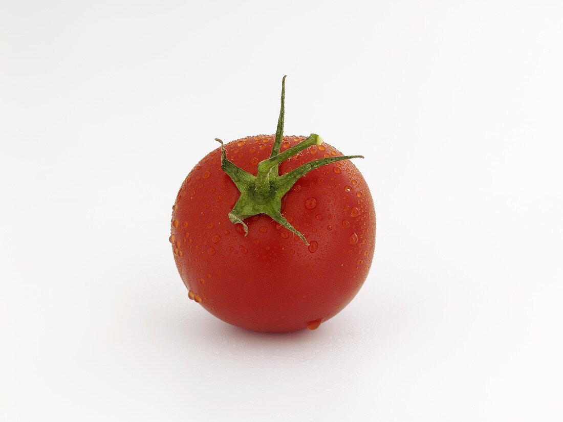 A tomato with drops of water