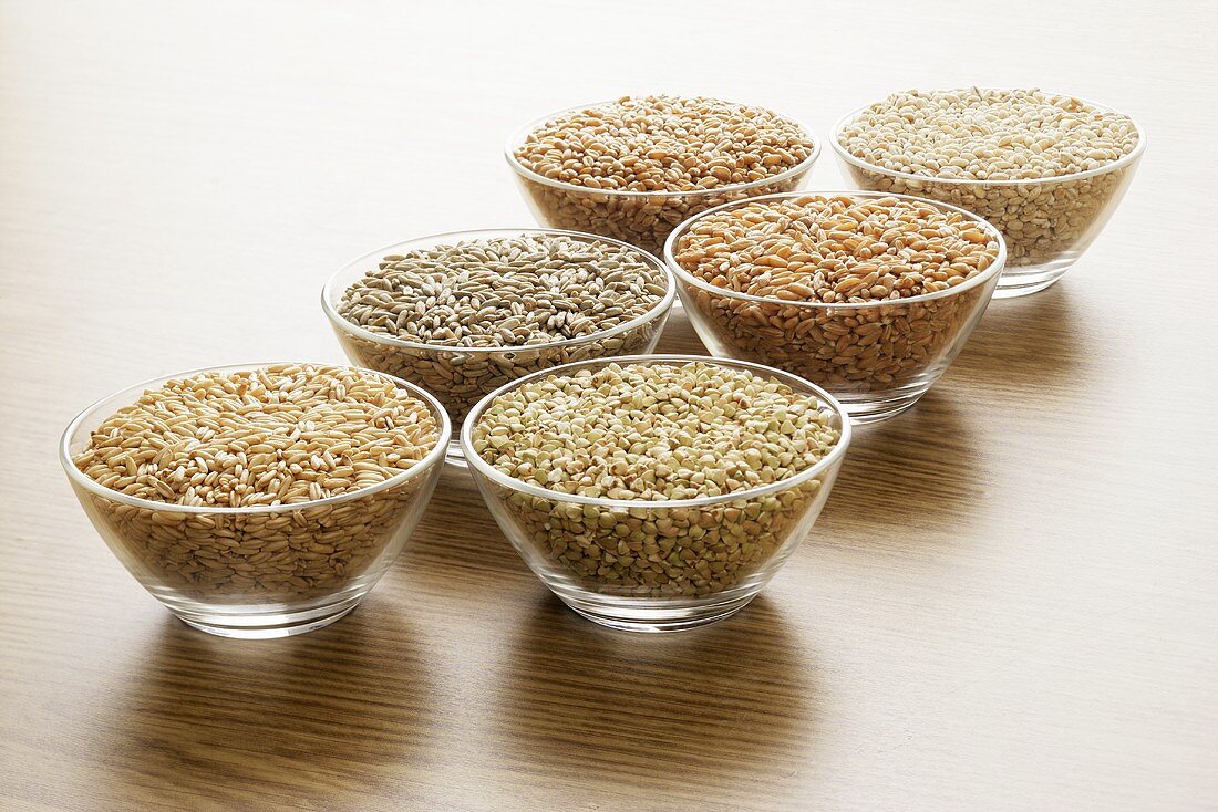 Various cereal grains in glass bowls