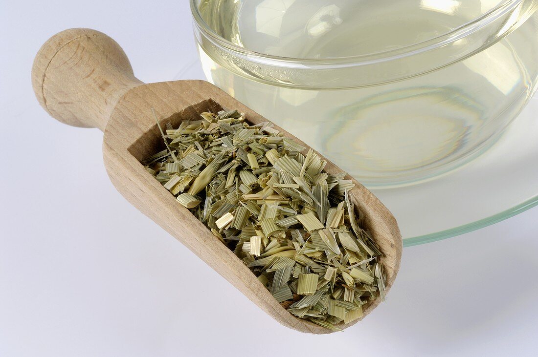 Dried oat straw and a cup of oat straw tea