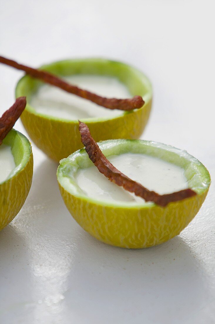 Cold melon yoghurt soup in hollowed-out melon halves