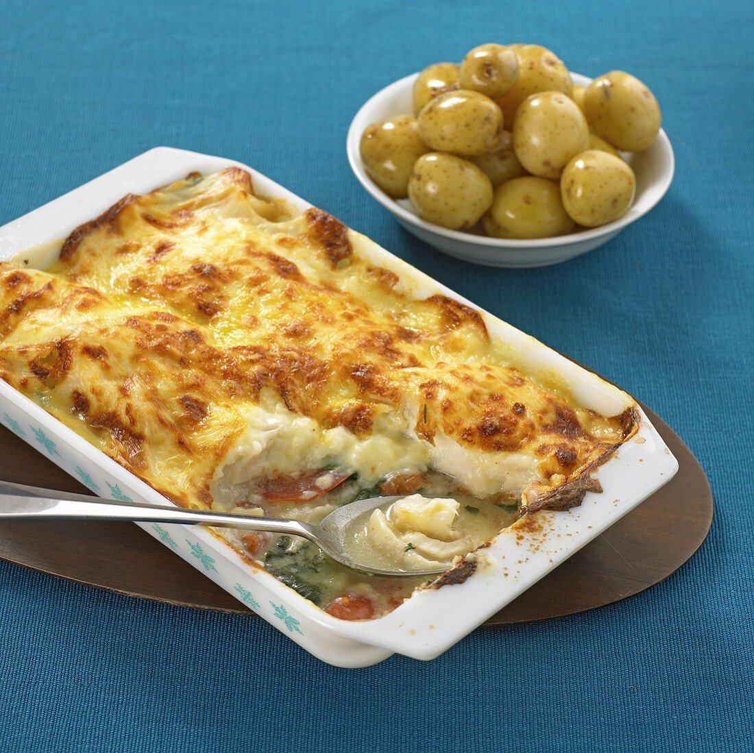 Fish pie, dish of olives in background