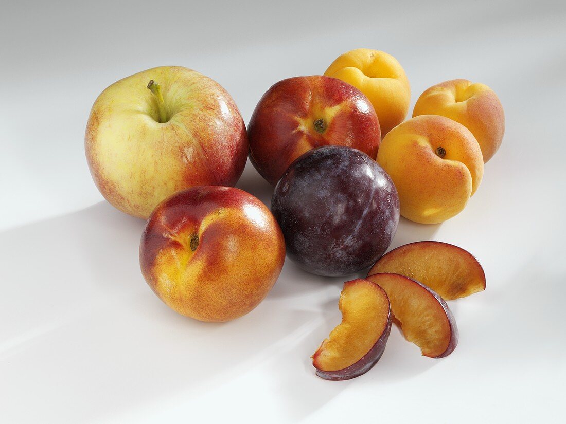 Still life with apple, nectarines, apricots and plums