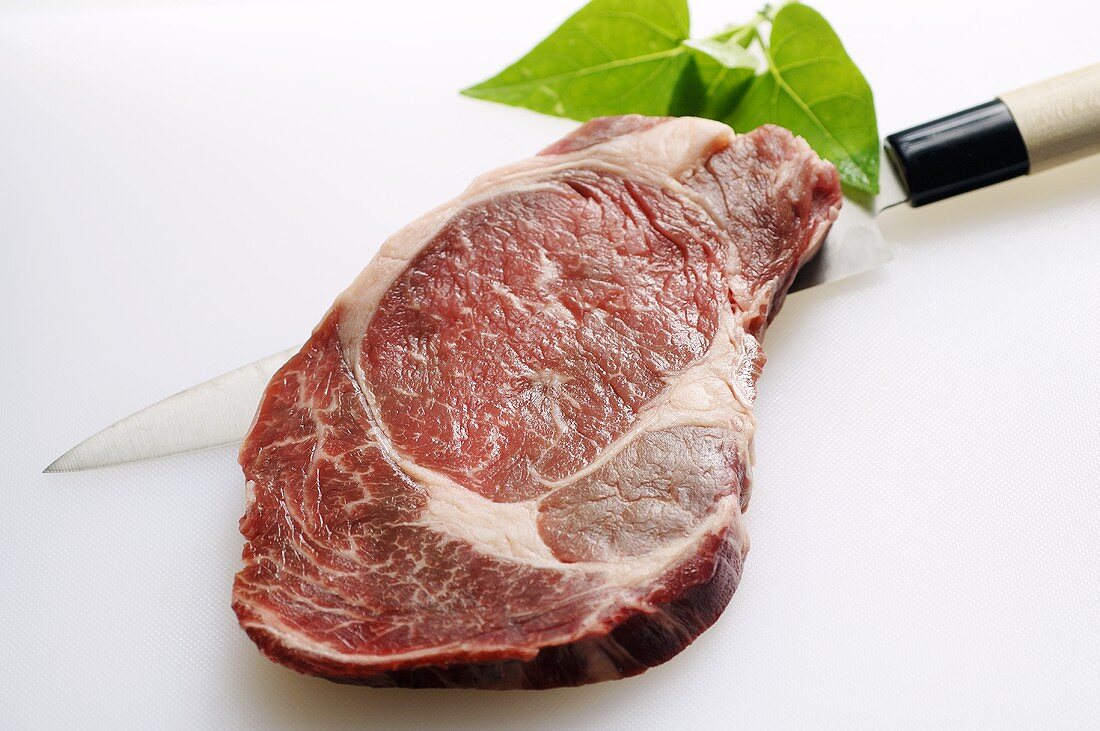 Rib eye steak on knife