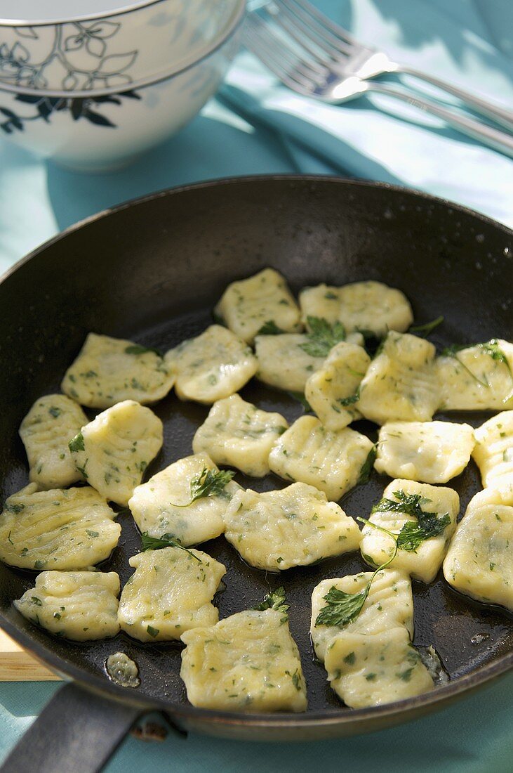 Herb gnocchi in a frying pan