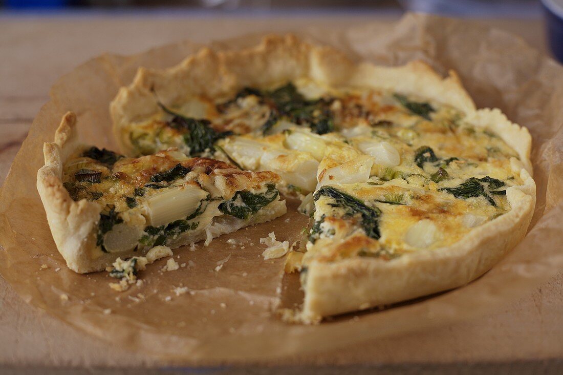 Asparagus quiche with a piece cut