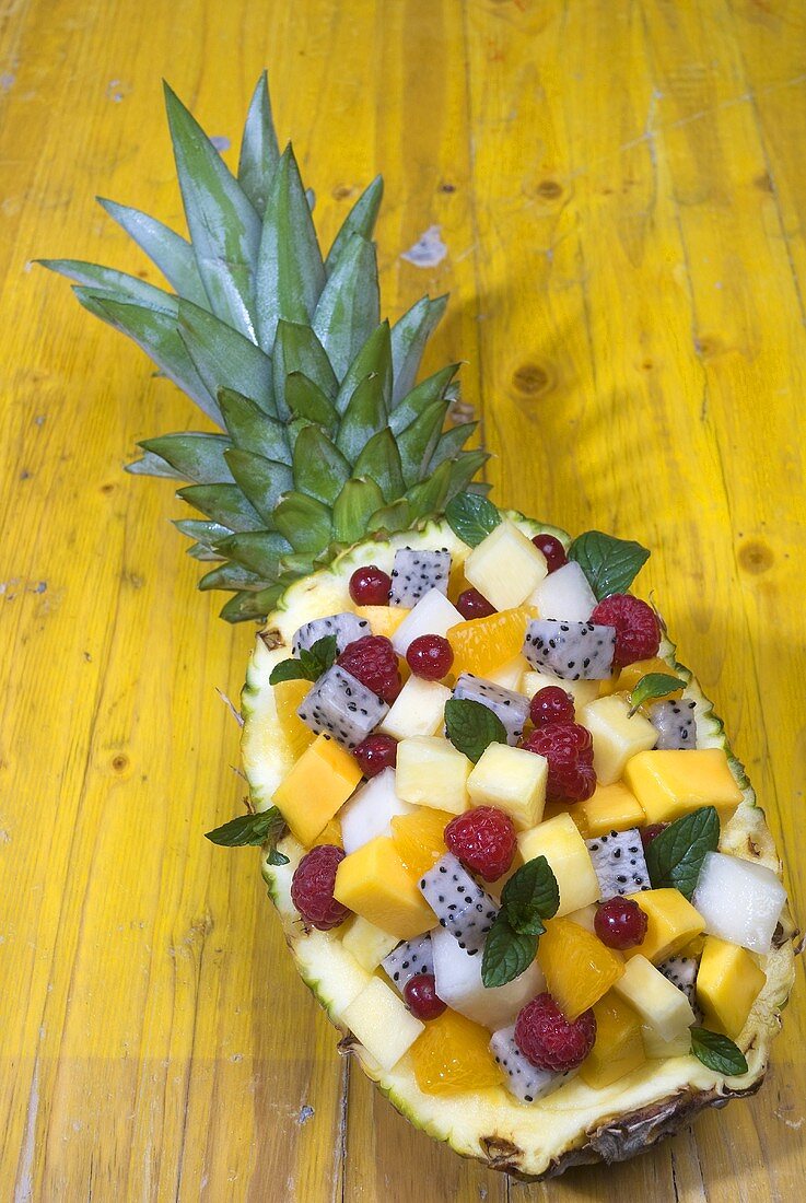 Exotic fruit salad in hollowed-out pineapple