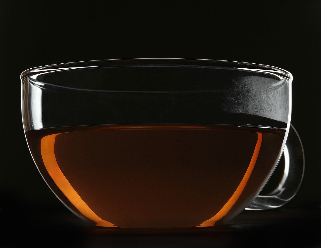 Tea in a glass cup and saucer