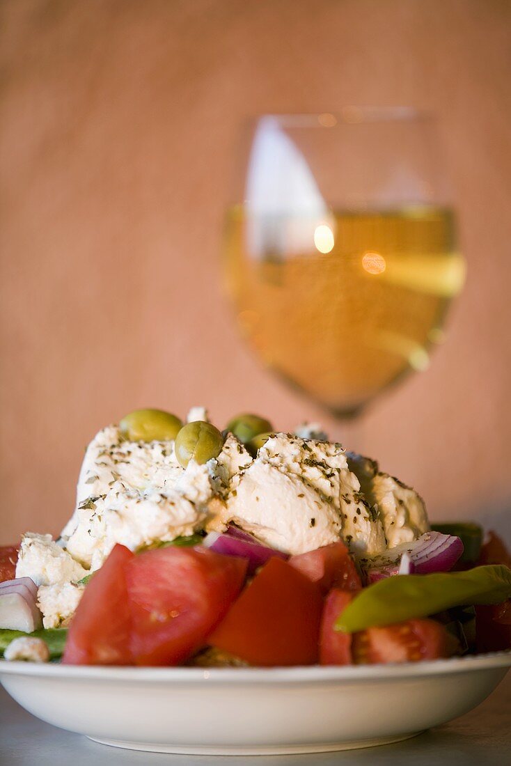 Greek salad and a glass of white wine