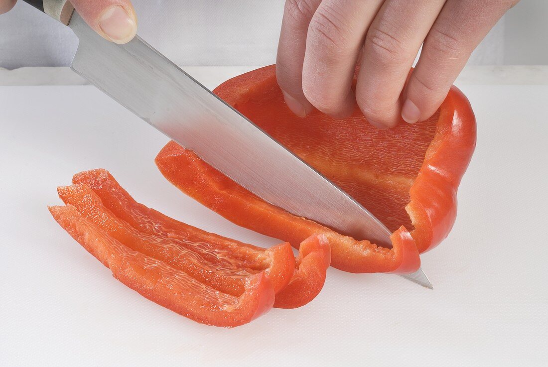 Cutting a pepper into strips