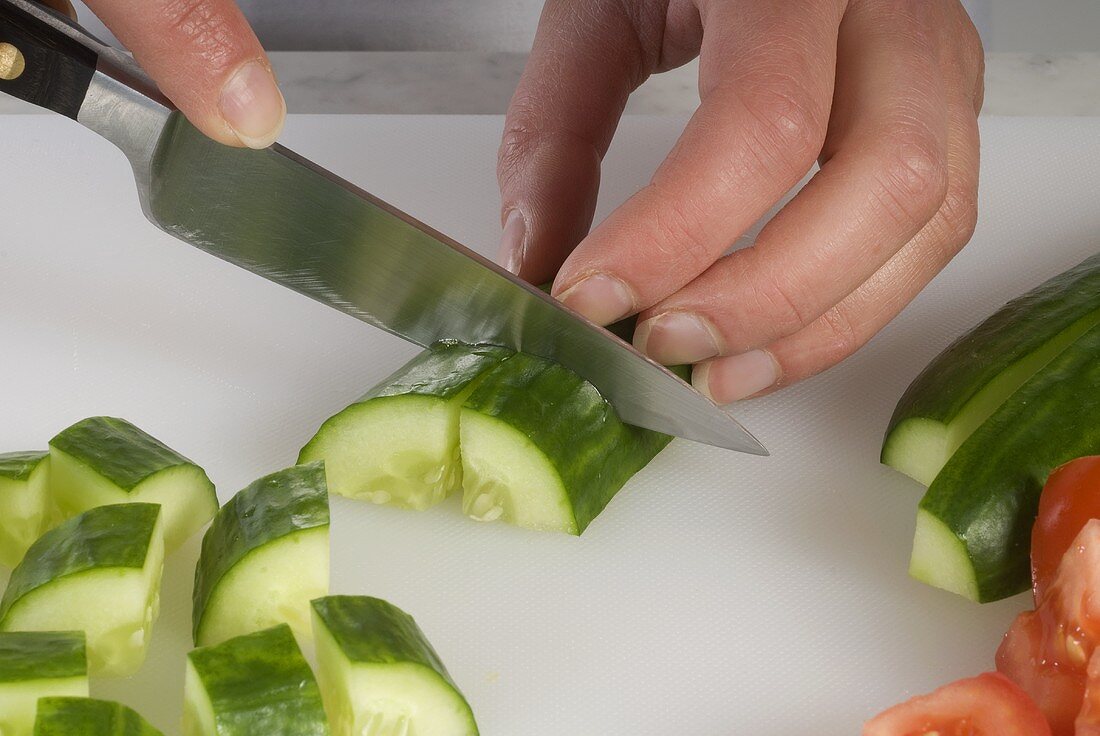 Eine Salatgurke schneiden