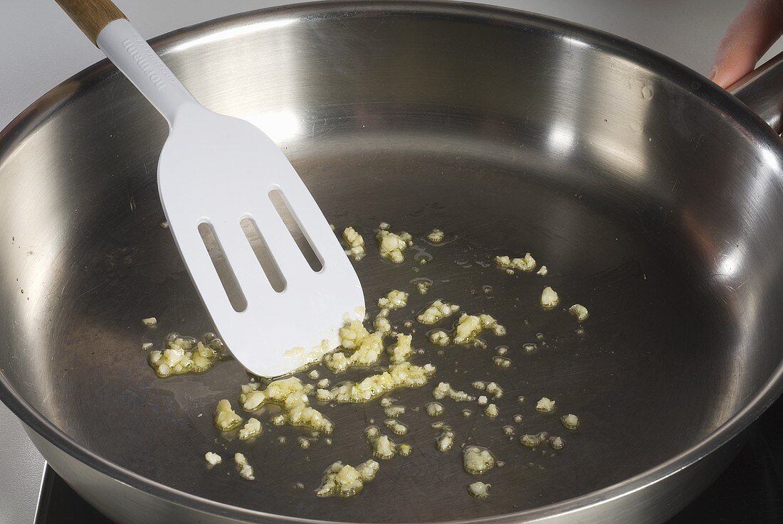 Sweating garlic in a frying pan