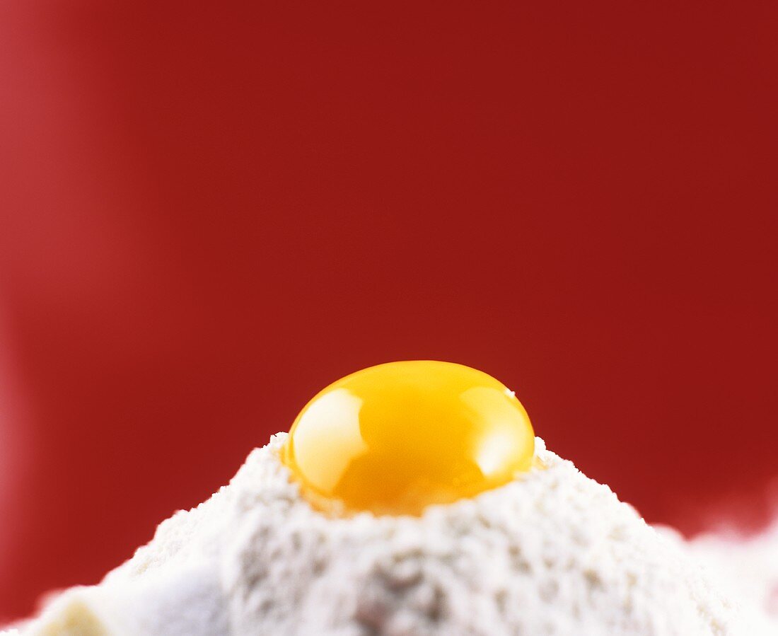 Pastry ingredients: egg on heap of flour