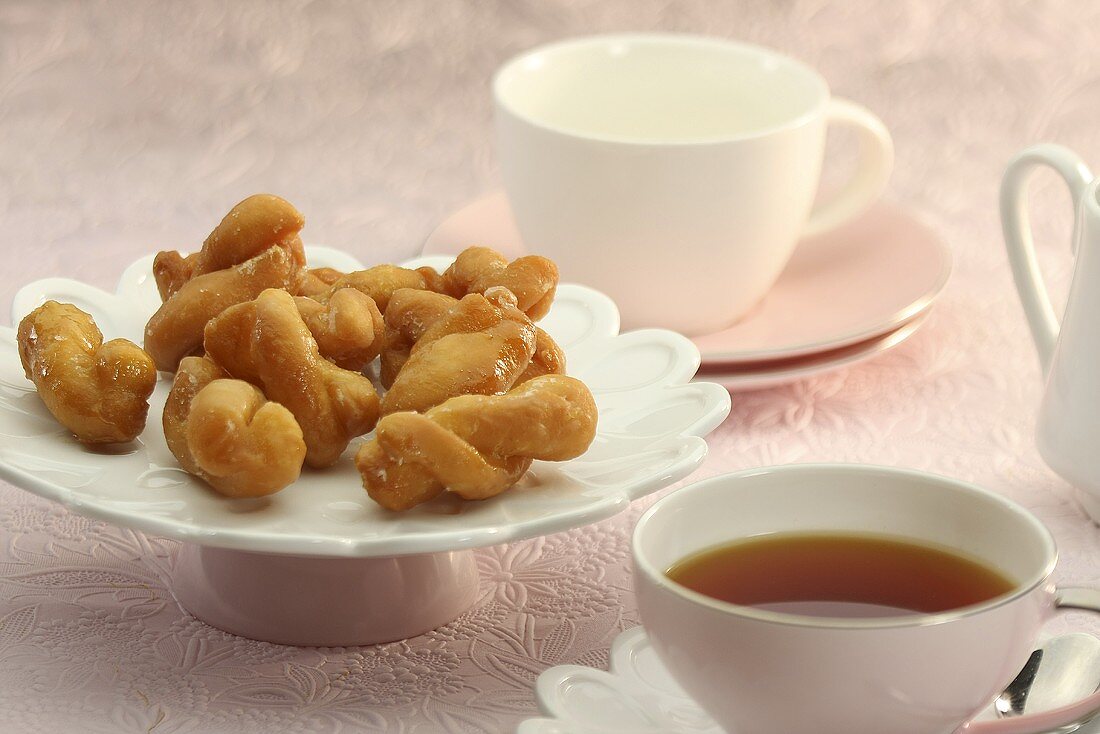 Koeksisters (South African fried dough plaits) with tea