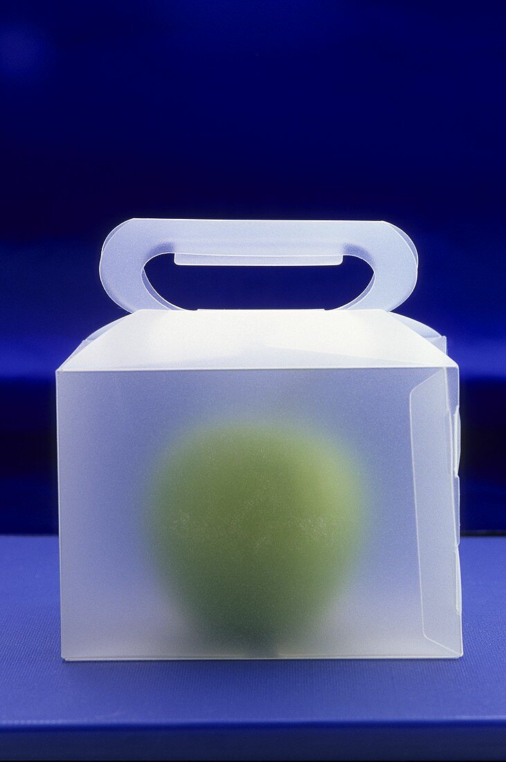 An apple in a carrying box