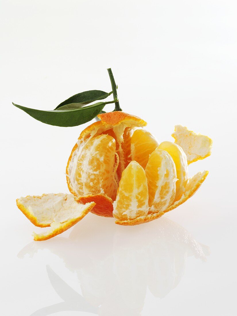 A clementine, partially peeled