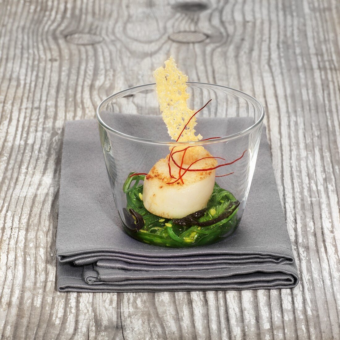 Fried scallops on an algae medley