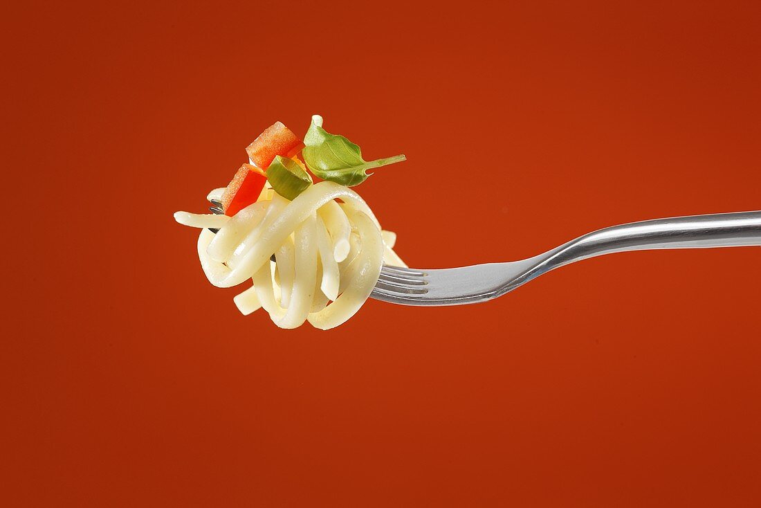 Pasta with vegetables on a fork