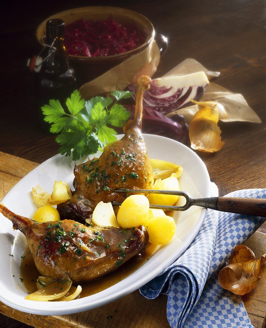 Goose leg with steamed potatoes and red cabbage