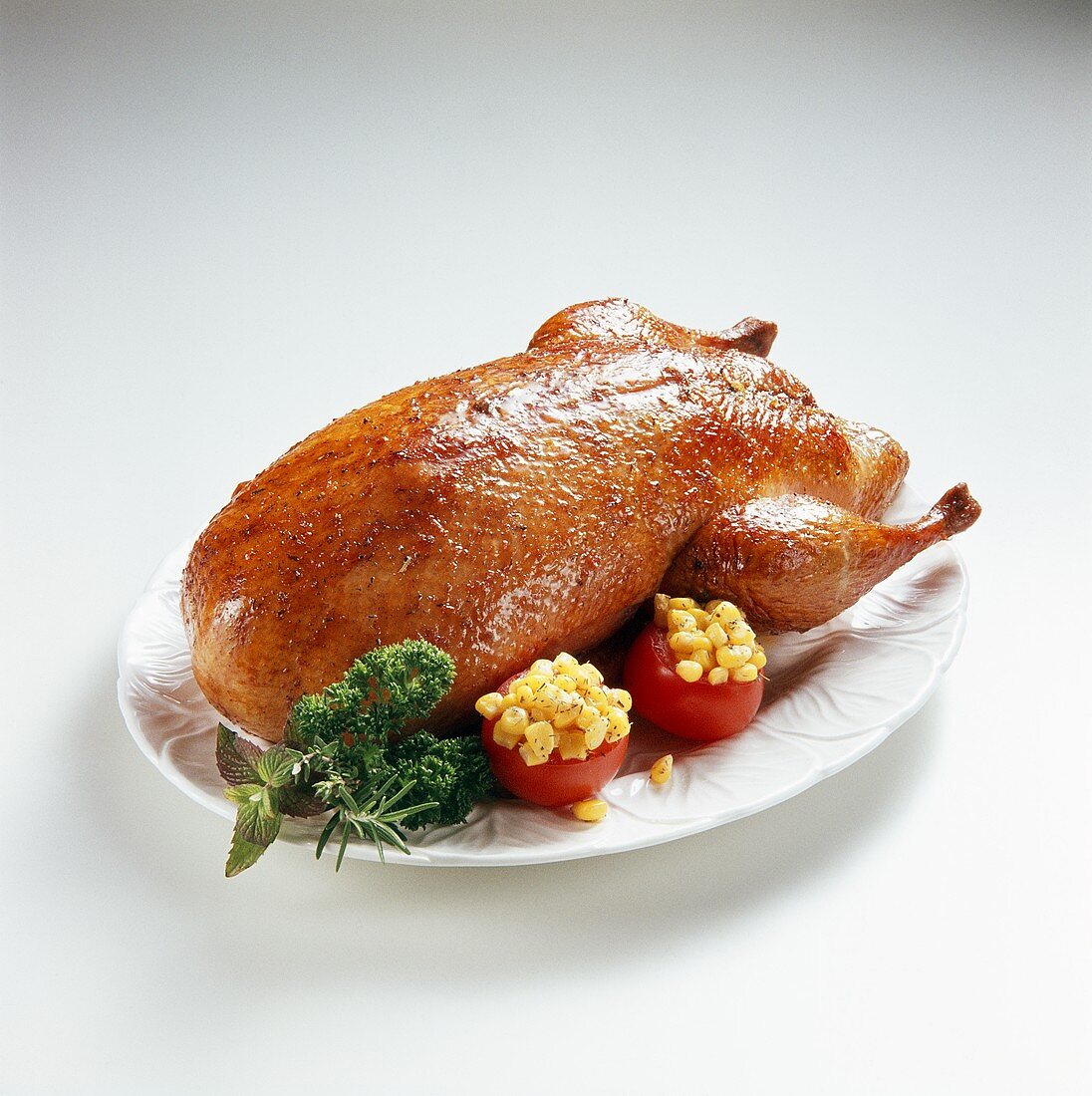 Roast duck with stuffed tomatoes