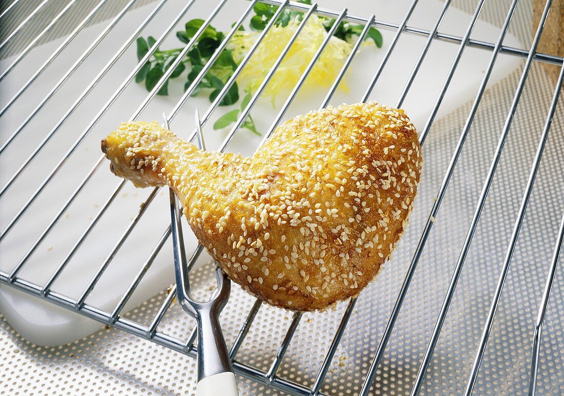 A chicken leg with a sesame seed crust