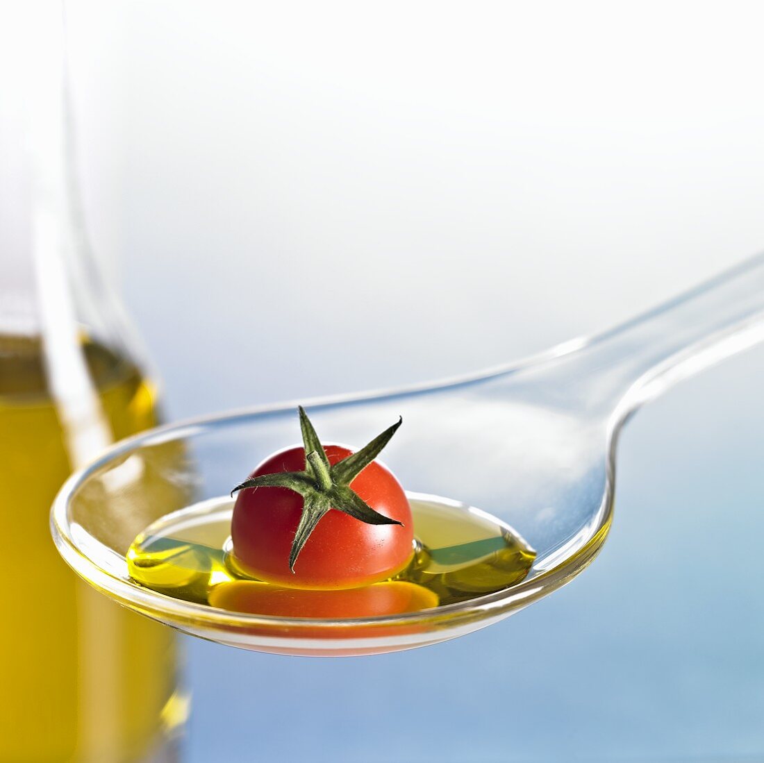 Cocktail tomato with oil on spoon