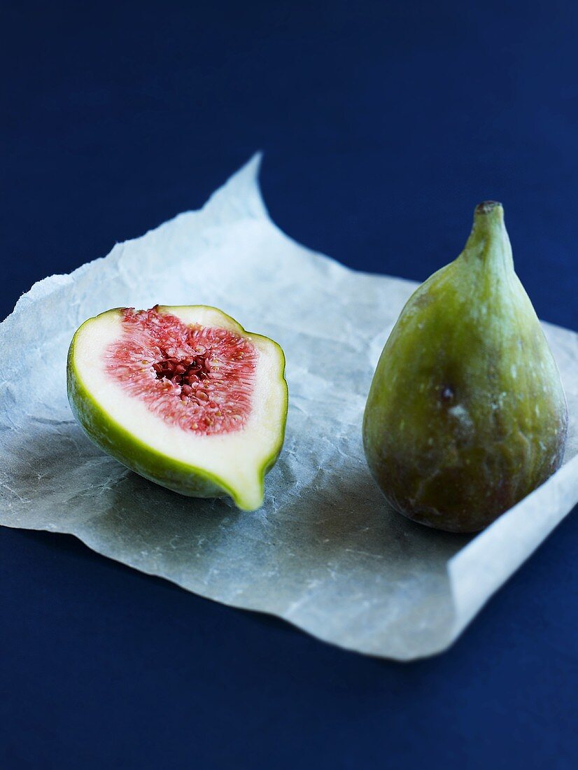 Whole fig and half a fig on parchment paper