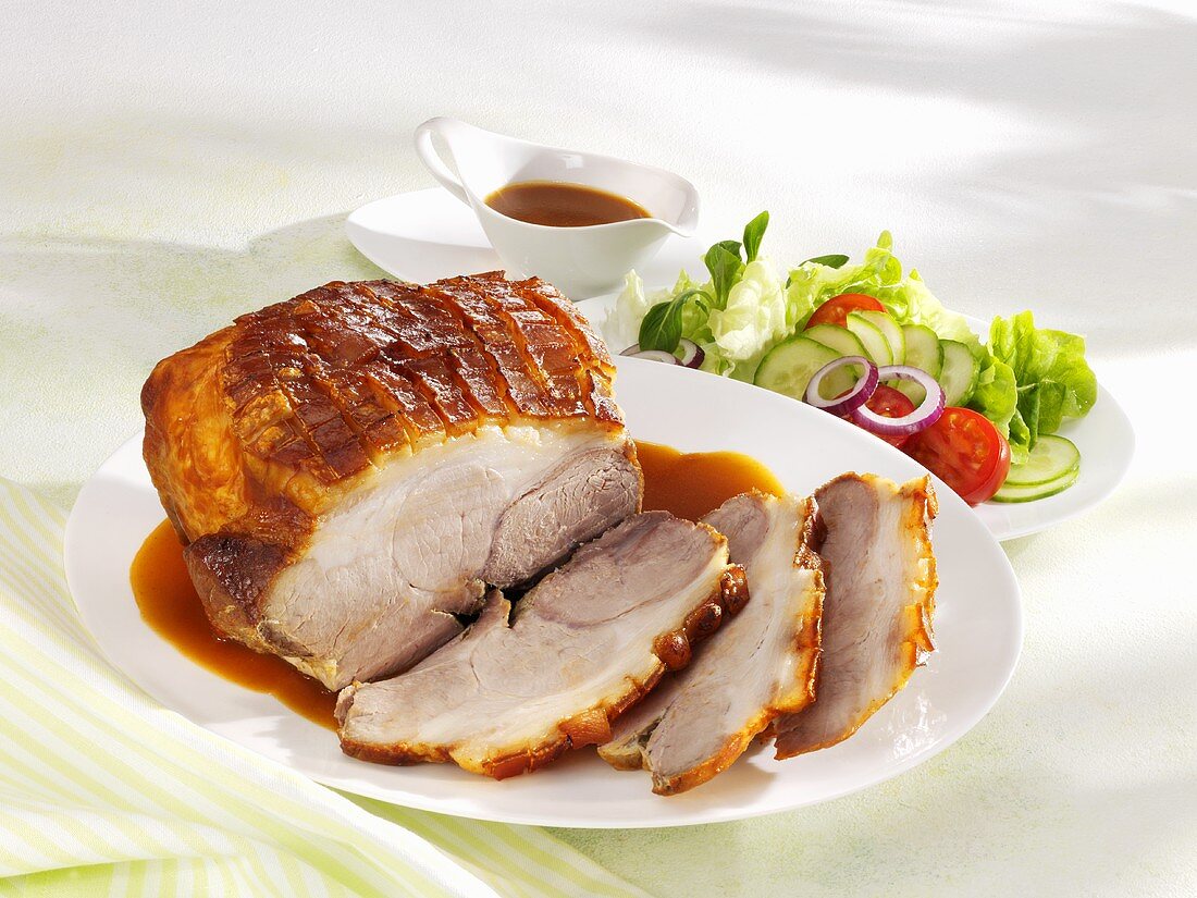 Roast pork with gravy and salad