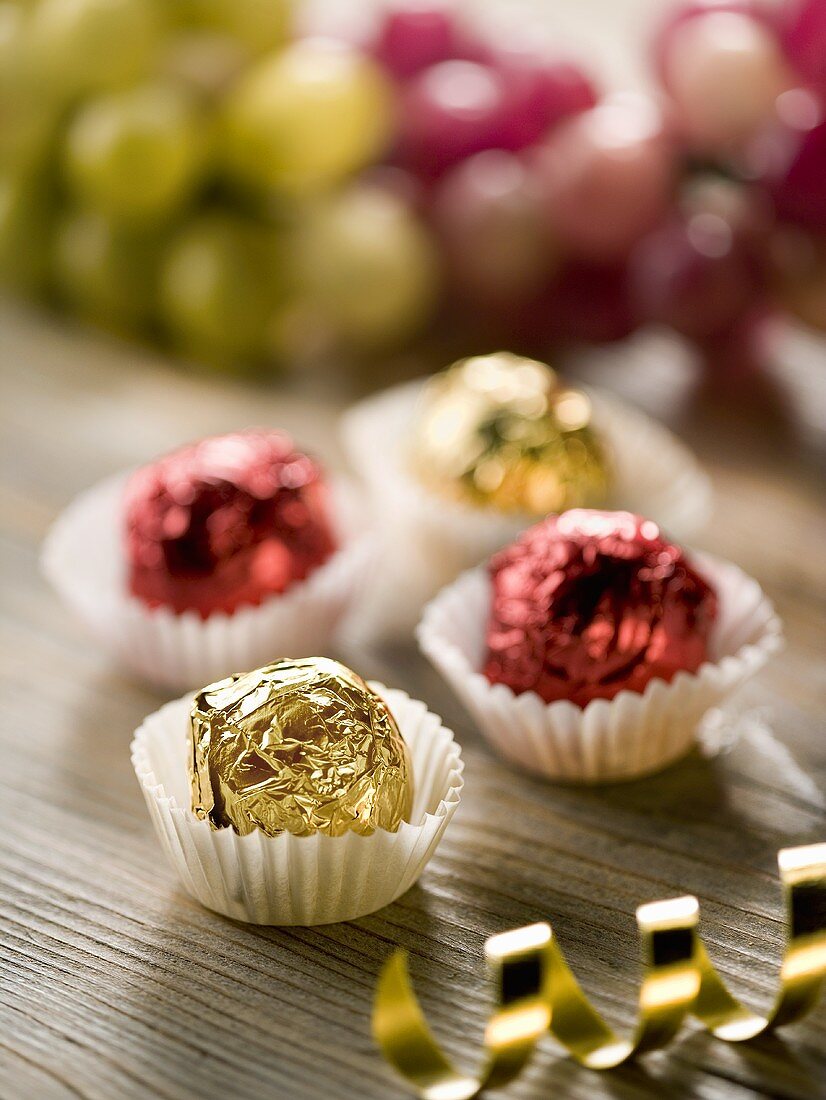 Four chocolates with wine jelly filling in shiny foil