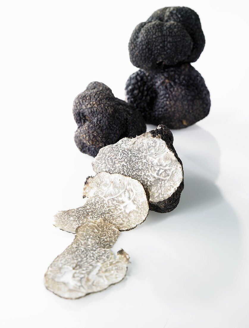 Black truffles, whole and partly sliced