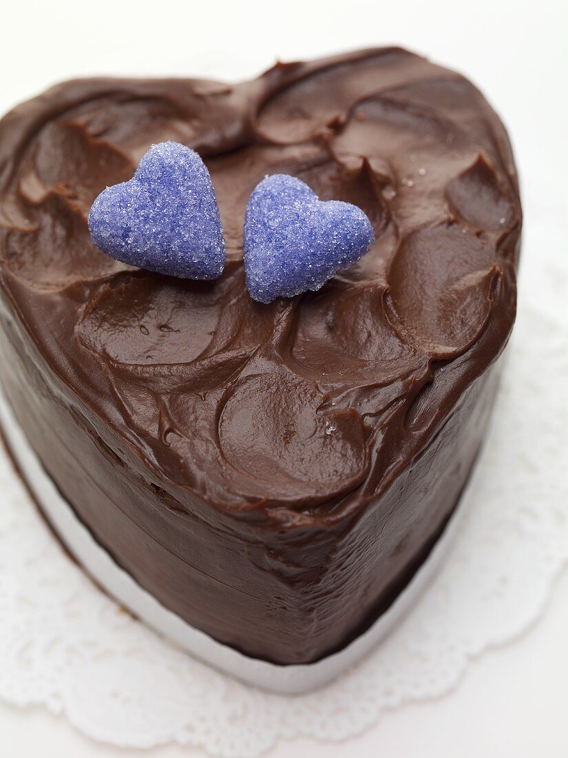 Heart-shaped chocolate cake with sugar hearts