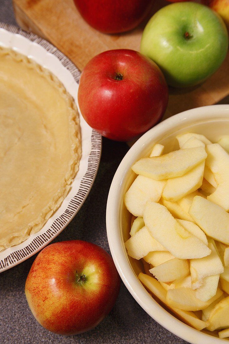 Whole and Sliced Apples with Pie Crust for Baking