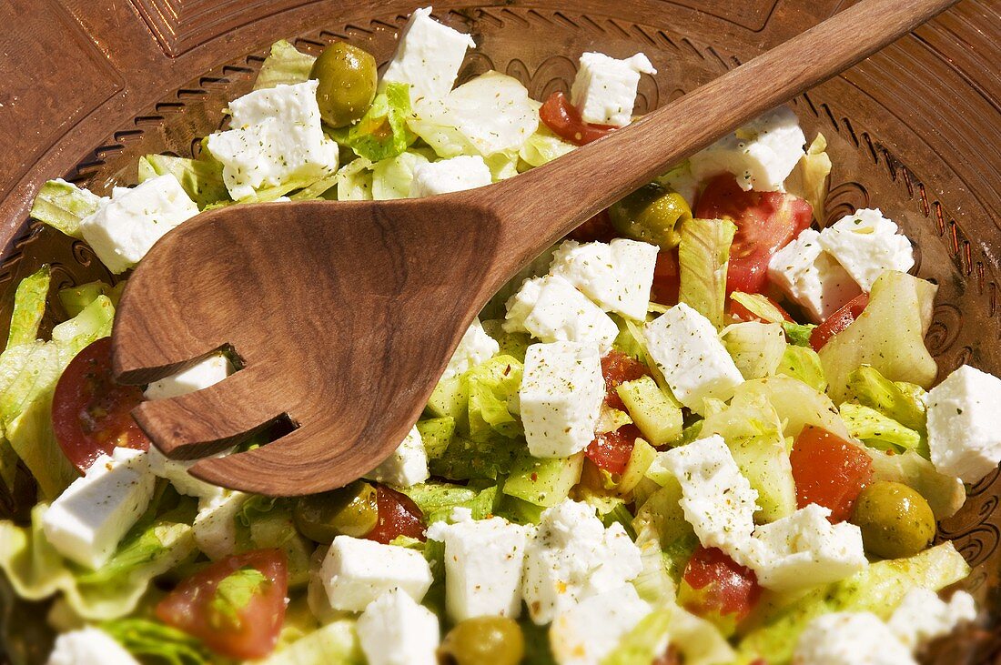 Greek salad with salad servers